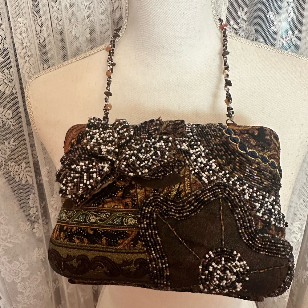 Metal handbag style is Bo-Ho... Beaded 2 straps.